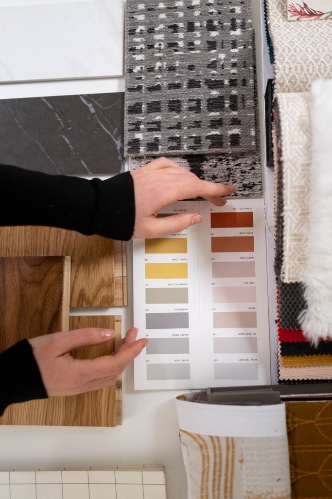 Uncategorized | Walnut Kitchens: The Return of Rich, Natural Wood Hands selecting fabric and color palettes for interior design projects.